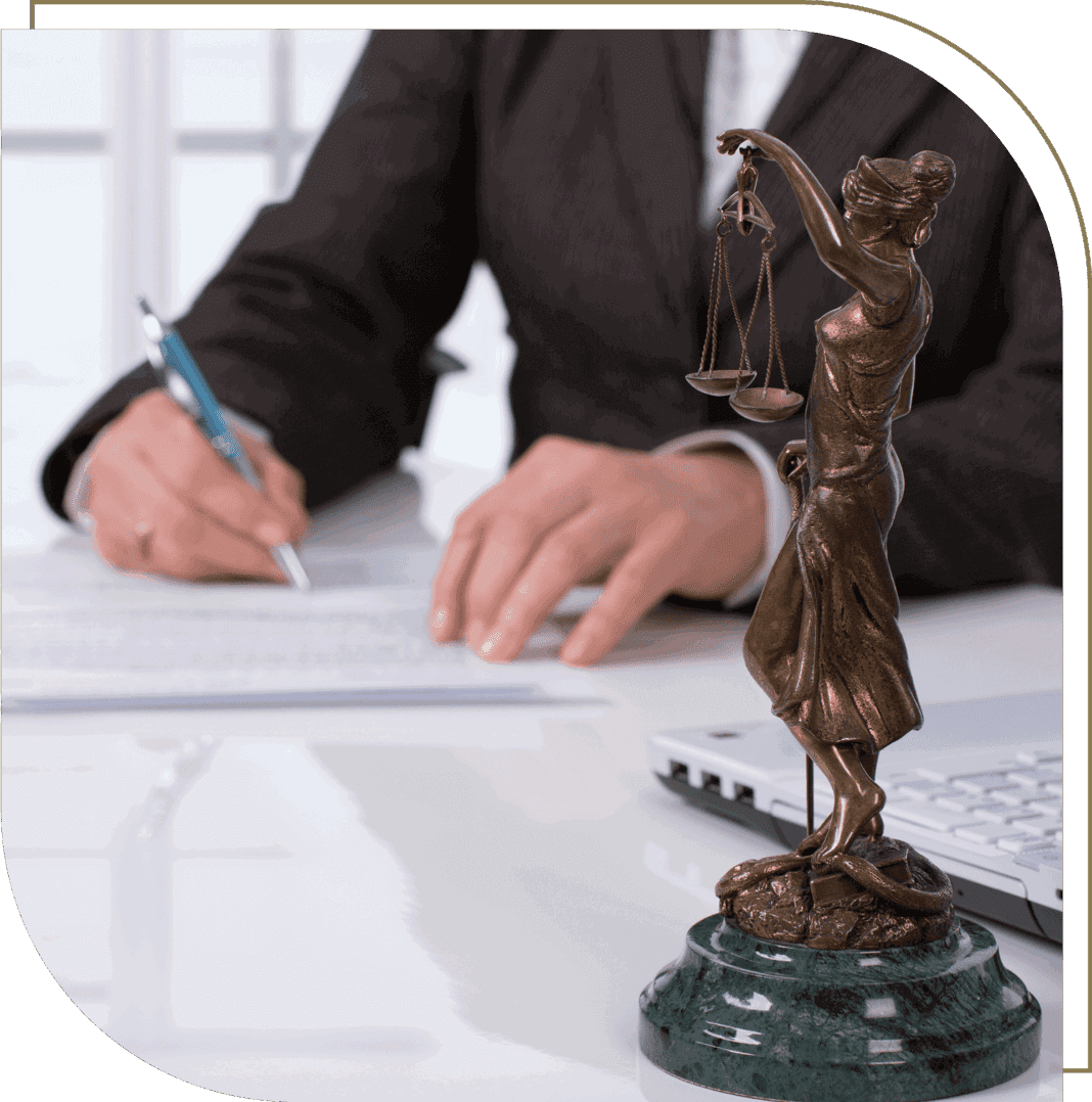 Justice statue and person writing documents.